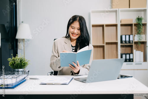 Business woman using tablet and laptop for doing math finance on an office desk  tax