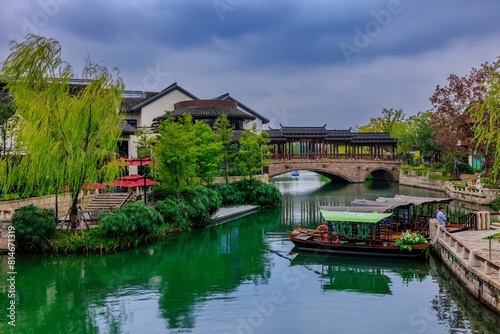 Canvas Print Picturesque arched bridge spanning a tranquil body of water on a cloudy day in S