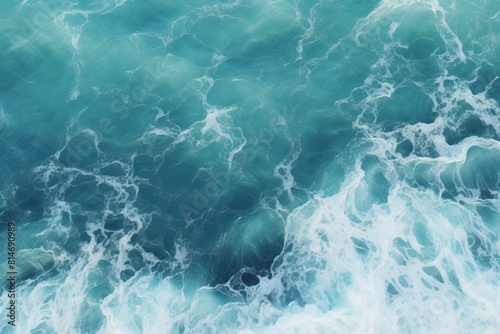 Tranquil aerial view of ocean waves creating a soothing natural pattern on the calm and peaceful marine surface, with a textured and photogenic turquoise backdrop © juliars