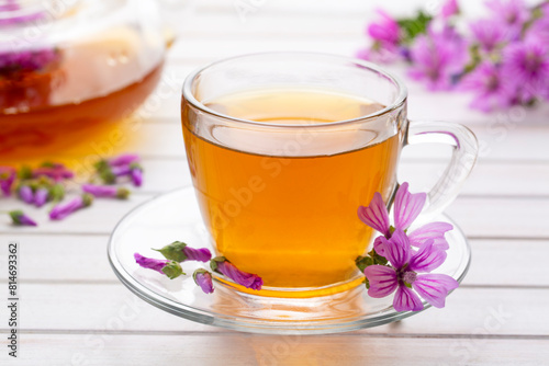 Mallow herb (Malva Vulgaris) mallow flower tea in cup.