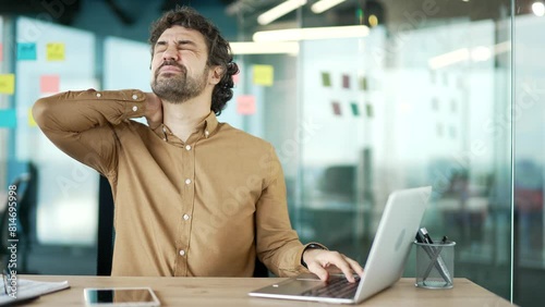 Wallpaper Mural Tired businessman suffering from neck pain while working on laptop sitting at desk at workplace in business office. Upset overworked man worker or entrepreneur massages rubs sore muscles, stretches Torontodigital.ca