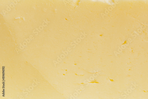 Sliced butter texture yellow background. Macro shot.