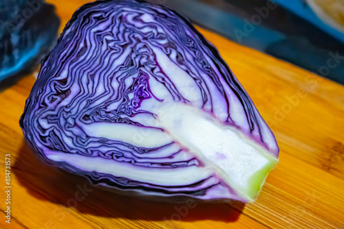 Chopped red cabbage close-up on a cutting wooden board in the kitchen