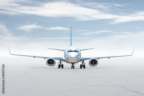 Front view of the white passenger jetliner isolated on bright background with sky