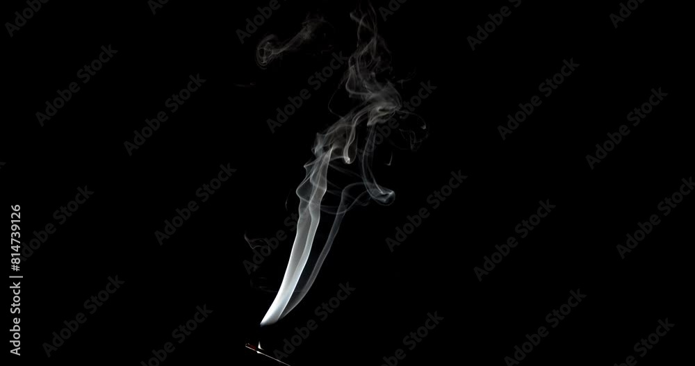 Real smoke on a black background. Thin Flexible Trickle of Real Smoke. Colorful real smoke rises up. Ideal for background or over-layer with blending mode add, screen, lighten.