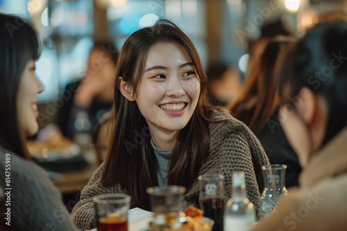 After a long day at the office  beautiful Korean businesswomen group gather at an izakaya to unwind. Clad in Private attire   they share stories  laughter  and sake 