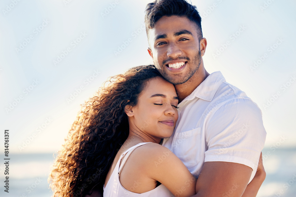 Love, couple and hug on beach with smile, anniversary and trust by ocean for holiday in Bali. Smiling man, woman and security on seaside with care for romance, relaxing and adventure on island