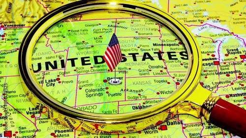 USA Map, video 4K. United States of America on the World map under magnifying glass and American Flag