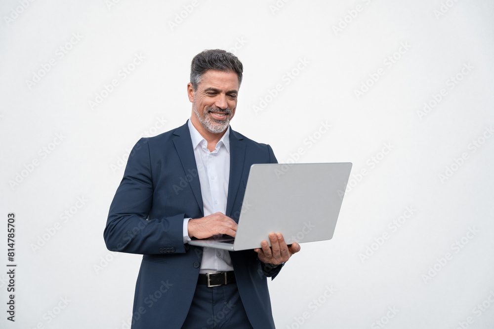 Portrait of middle age mature businessman using pc laptop for business work. Smiling handsome latin older man in formal suit holding wireless desktop computer. Isolated white background, copy space Portrait of middle age mature businessman using pc laptop for business work. Smiling handsome latin older man in formal suit holding wireless desktop computer. Isolated white background, copy space