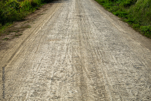The Dirt Road is Rough and Full of Potholes, Marking the Entrance to a Poor Rural Village © thaiprayboy