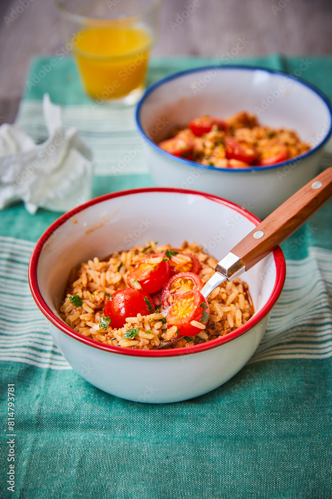Bowls of seasoned rice with tomatoes