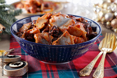 Pieces of marinated herring in tomato sauce with the addition of mushrooms and prunes photo