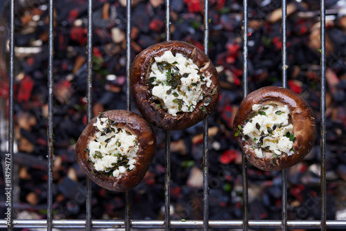Grilled stuffed mushrooms on a grill grate photo