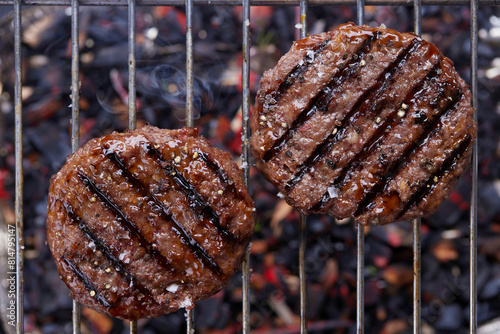 Grilled burger patties on a grill rack