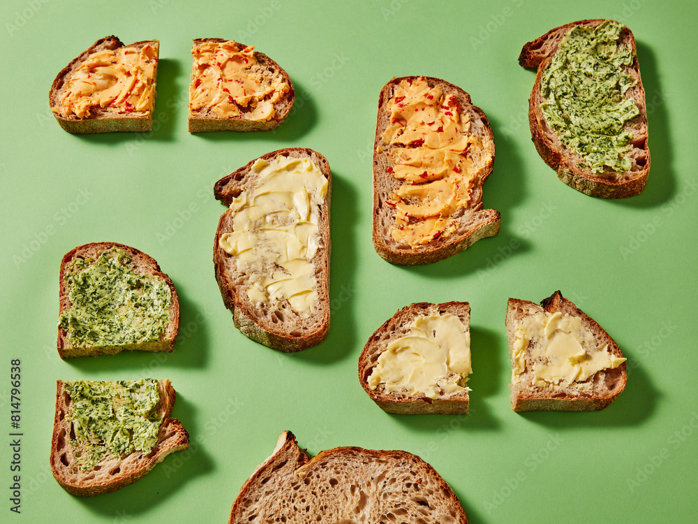 Slices of bread with various spreads on a green background Slices of bread with various spreads on a green background