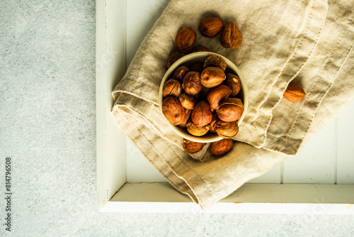 Bowl with organic hazelnuts on the napkin photo