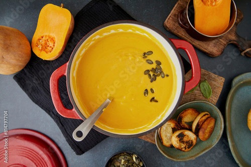 Pumpkin soup with toasted bread and pumpkin seeds photo