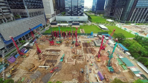 Singapore city, Singapore - 16th march, 2023: time lapse of cranes motion at work in construction site building new skyline building in business district downtown area