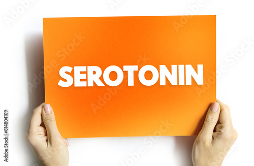 Serotonin is a chemical that carries messages between nerve cells in the brain and throughout your body, text concept on card photo