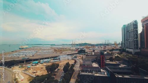 Singapore city, Singapore - 16th march, 2023: static timelapse MCE highway and cars driving by Tanjong Pagar port freight terminal. Shipping, imports exports concept asia