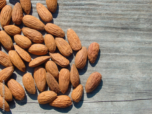 Dried almonds. Almond kernels on wooden background. Peeled almonds. Top view