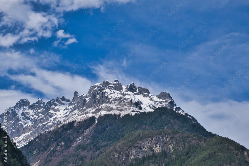 Mountain peaks covered with snow in Switzerland, blue cloudy sky Mountain peaks covered with snow in Switzerland, blue cloudy sky
