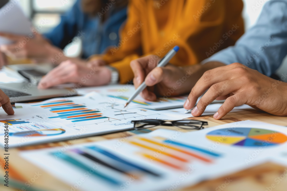 Hands business team having a meeting to analyze data graph charts for a marketing plan. Hands business team having a meeting to analyze data graph charts for a marketing plan.
