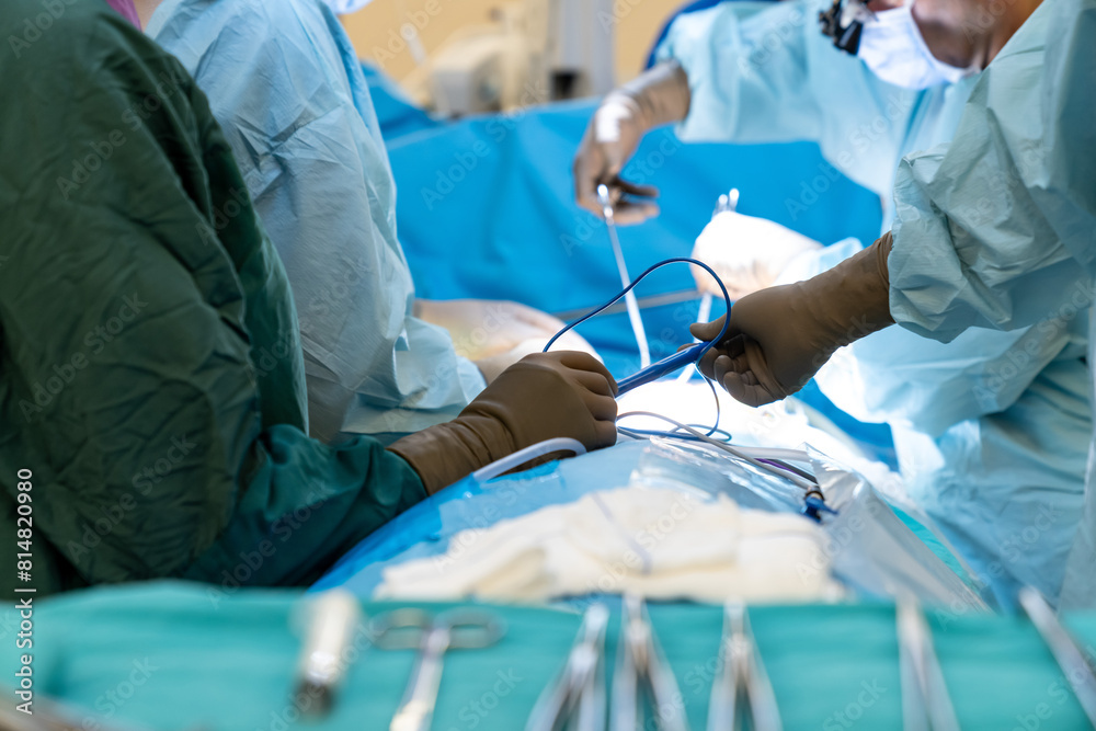 Sterile surgical instruments and tools including scalpels, scissors, forceps and tweezers arranged on a table for a surgery, Sterilized surgical instruments on the blue or green wrap Sterile surgical instruments and tools including scalpels, scissors, forceps and tweezers arranged on a table for a surgery, Sterilized surgical instruments on the blue or green wrap