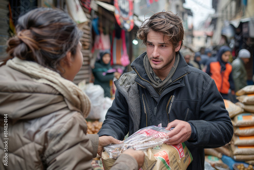 Compassionate volunteer is distributing much-needed food aid to families struggling with poverty in busy street