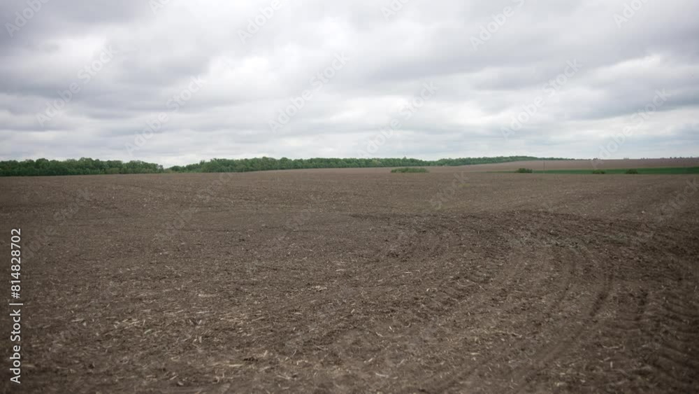 Aerial view of plowed field under cloudy sky Aerial view of plowed field under cloudy sky
