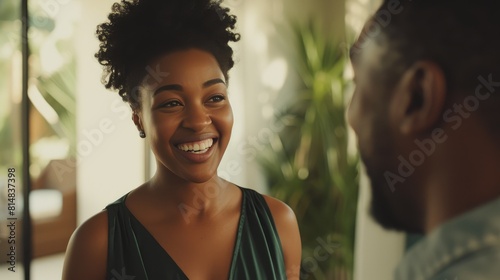 Joyful African American couple in stylish attire, warm home ambiance, sunny day