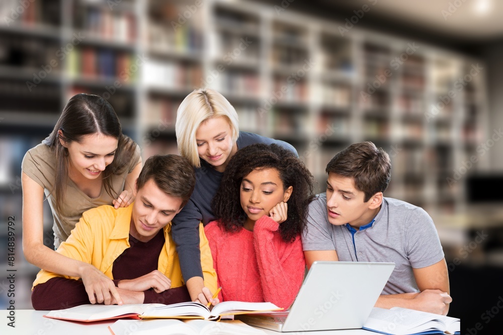 Diverse group of happy students chatting in college library Diverse group of happy students chatting in college library