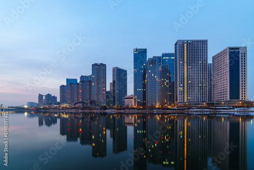 Skyscrapers reflection upon a river at dawn in Tongzhou District, Beijing, China, which is a newly-established business district