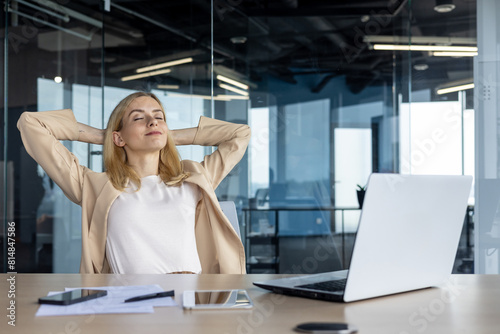 Billede på lærred Relaxed businesswoman taking a break at office desk with eyes closed