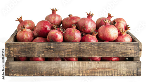 Fresh red pomegranates in a wooden basket on clean white background