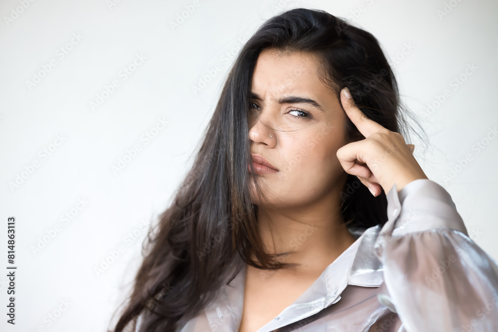 Angry Indian woman pointing at her head, body gesture for asking you to think, stop doing stupid things Angry Indian woman pointing at her head, body gesture for asking you to think, stop doing stupid things