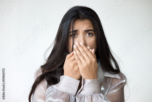 Fearful and speehless Indian woman covers her mouth, South Asian woman can not speak freely due to censorship, no free speech, no freedom of speech concept photo