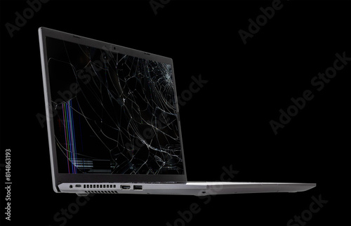laptop with a broken, cracked screen isolated on black background close up side view