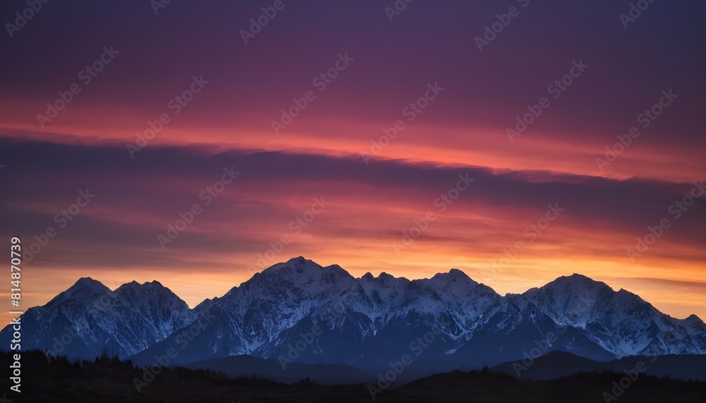 A majestic mountain range silhouetted against a co upscaled_3