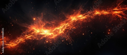 A copy space image of blazing flames against a black backdrop with red hot sparks ascending and fiery orange particles flying