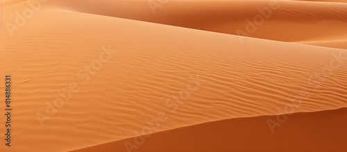 A background of orange sand with plenty of empty space for adding an image. Copyspace image