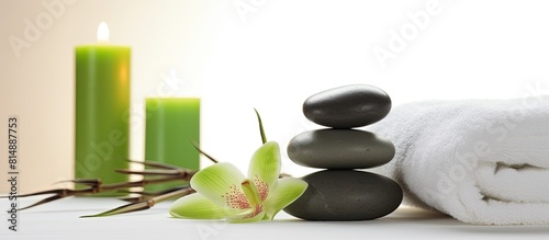 A serene copy space image of a spa set placed on a white background with a plush green towel
