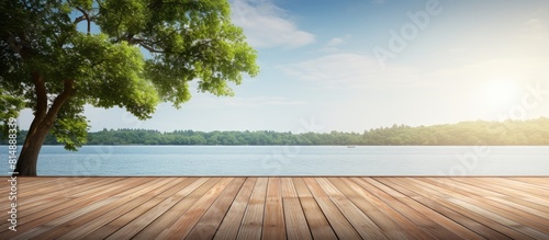 The image shows a wooden deck floor extending towards a serene body of water providing a beautiful and peaceful setting. Copyspace image