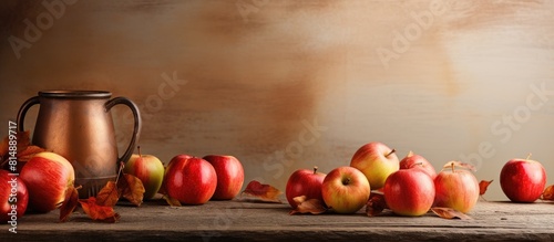 Autumn themed drink with a mug of chilled apple cider accompanied by a wooden tray filled with ripe red apples Ample copy space available