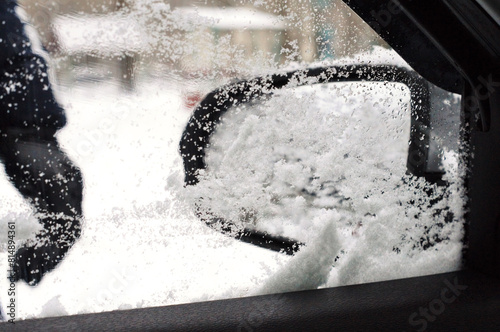 Winter has come. View of a snow-covered car mirror