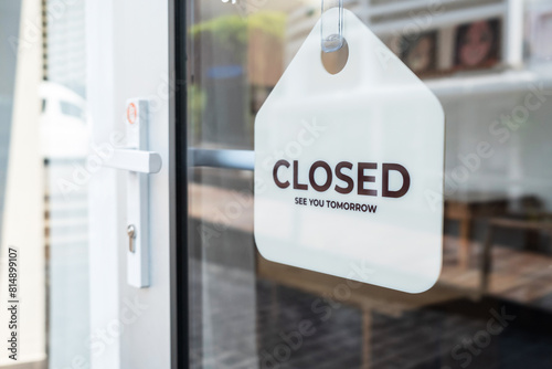 Sign text hangs on the entrance door of the shop, restaurant, cafe. That reads "closed". Business concept © Ton Photographer4289