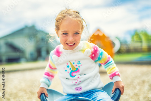 Child girl, Playing on Playground in spring time