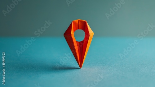 An illustration of an orange pin location made from origami. Location point made of orange paper on a plain background.