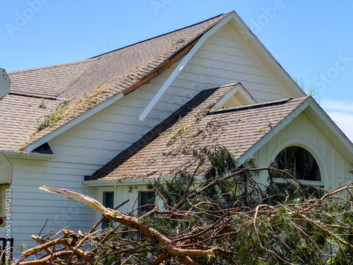 Roof Damage to a home with fallen trees from Tornado in Michigan