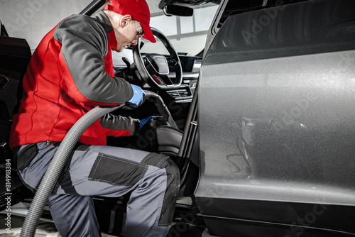 Automotive Worker Cleaning Car Interior With Vacuum © Tomasz Zajda